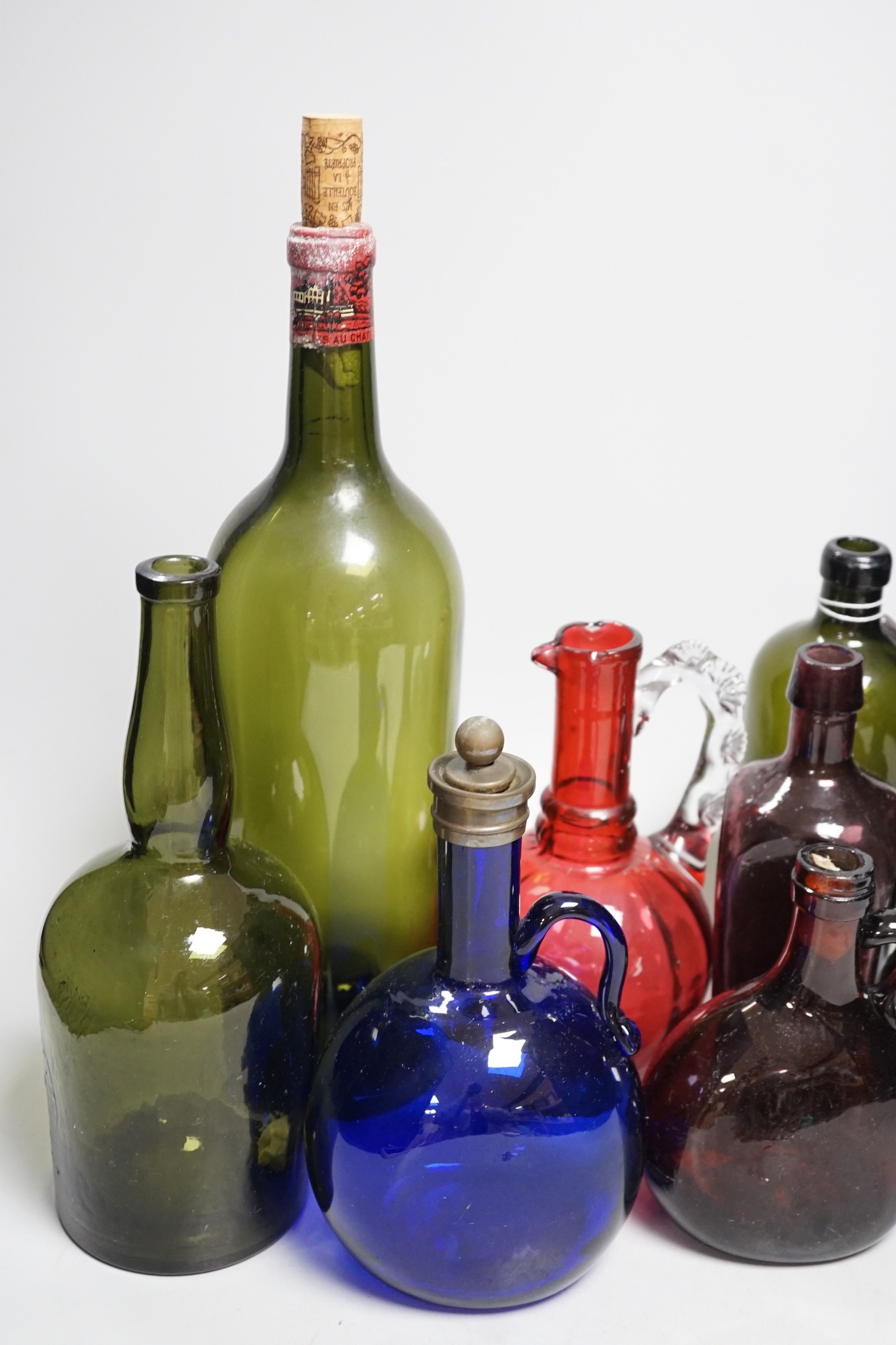A collection 19th/20th century coloured glass bottles and jugs